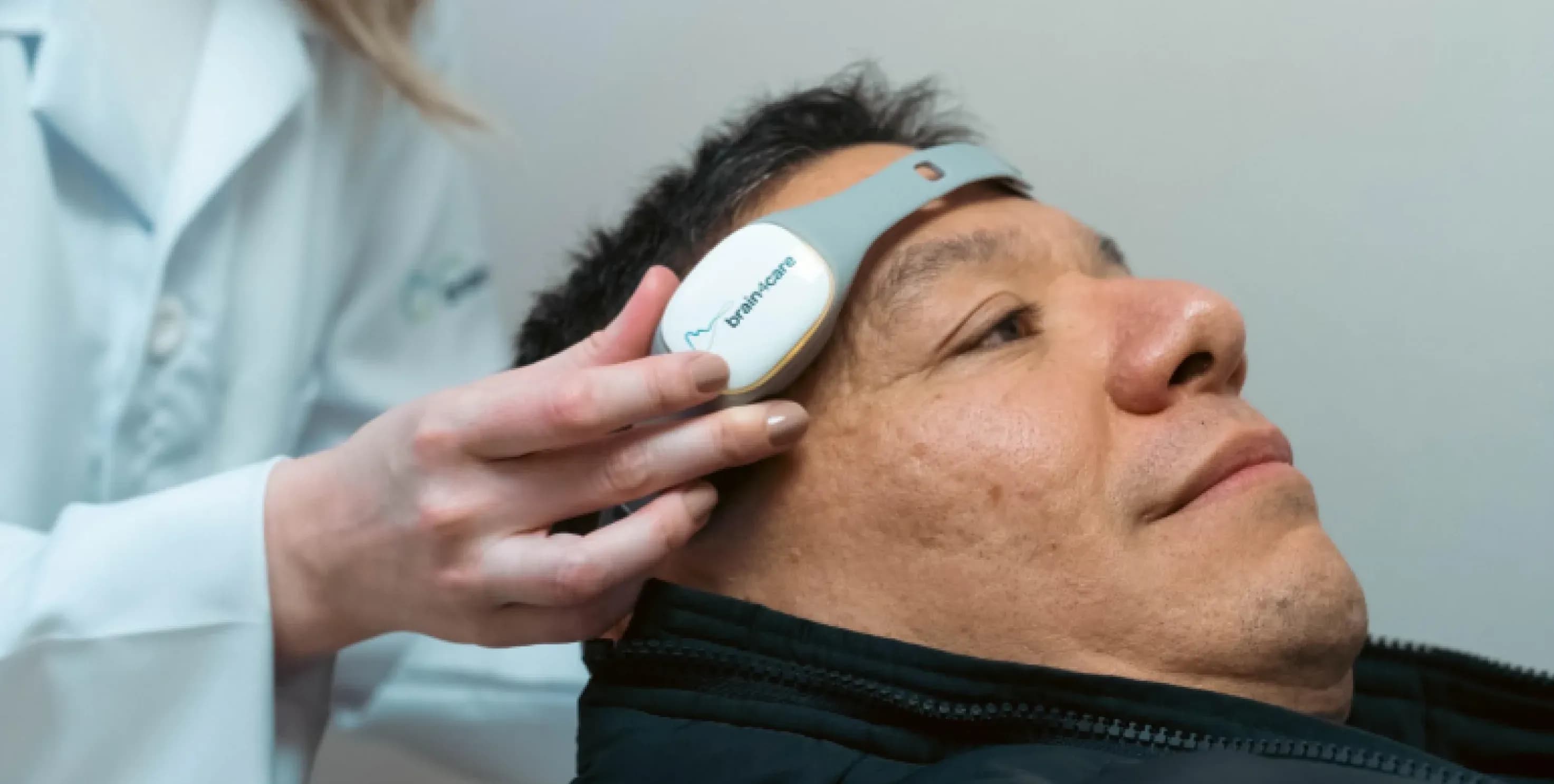 Healthcare — clinician fitting a brain4care sensor on a patient